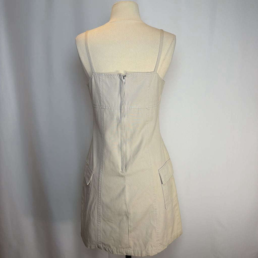 Beige dress on a mannequin against a plain background