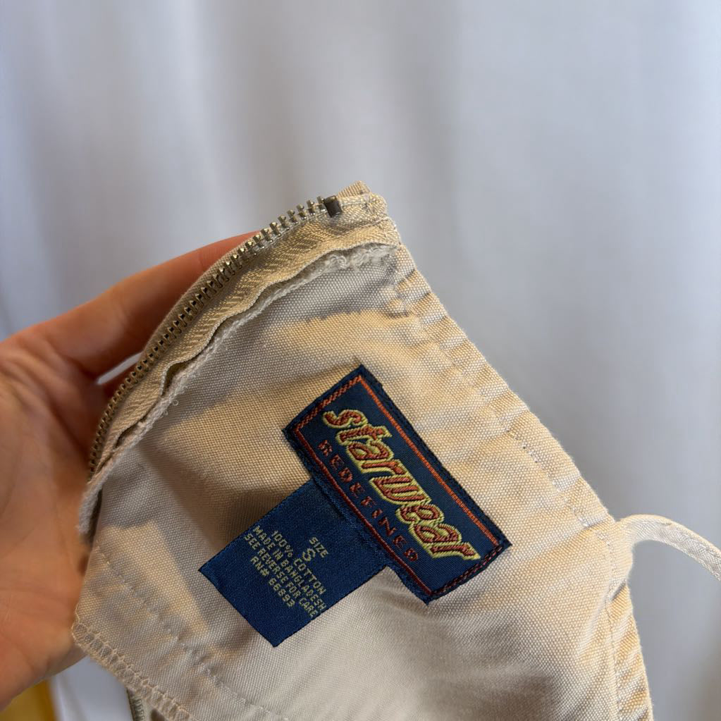 Close-up of a beige fabric item with a label on a light gray background