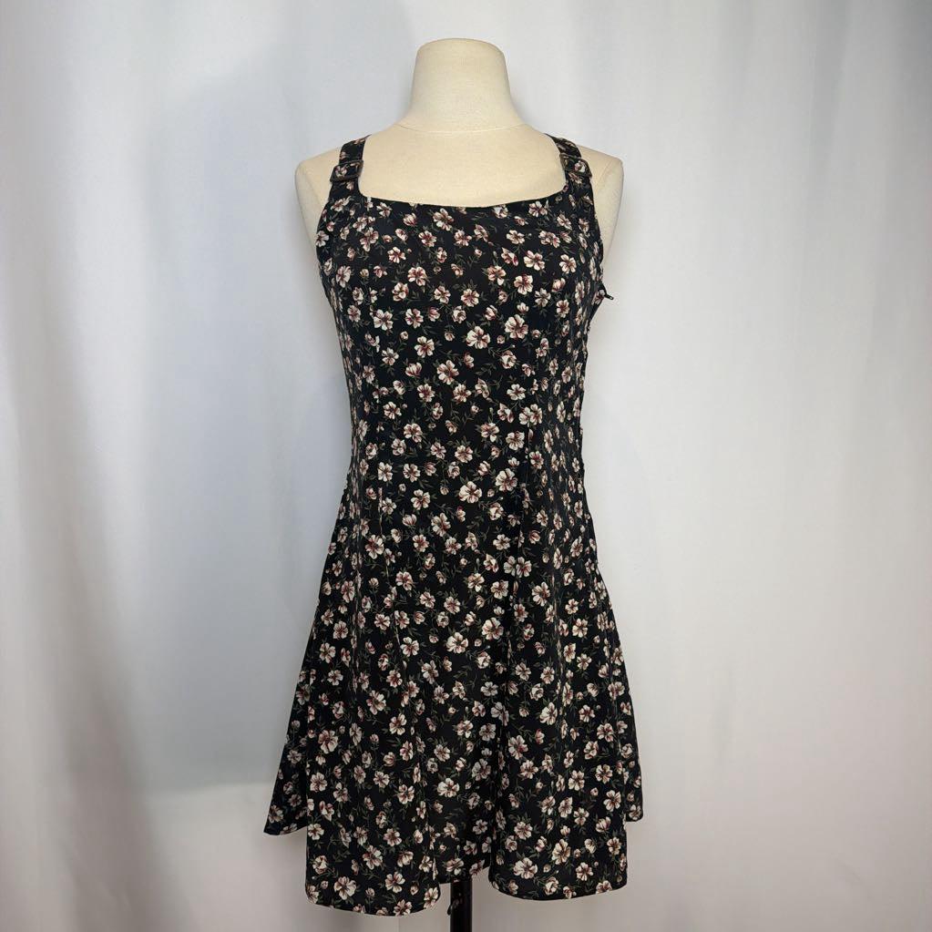 Black floral dress on a mannequin against a white background