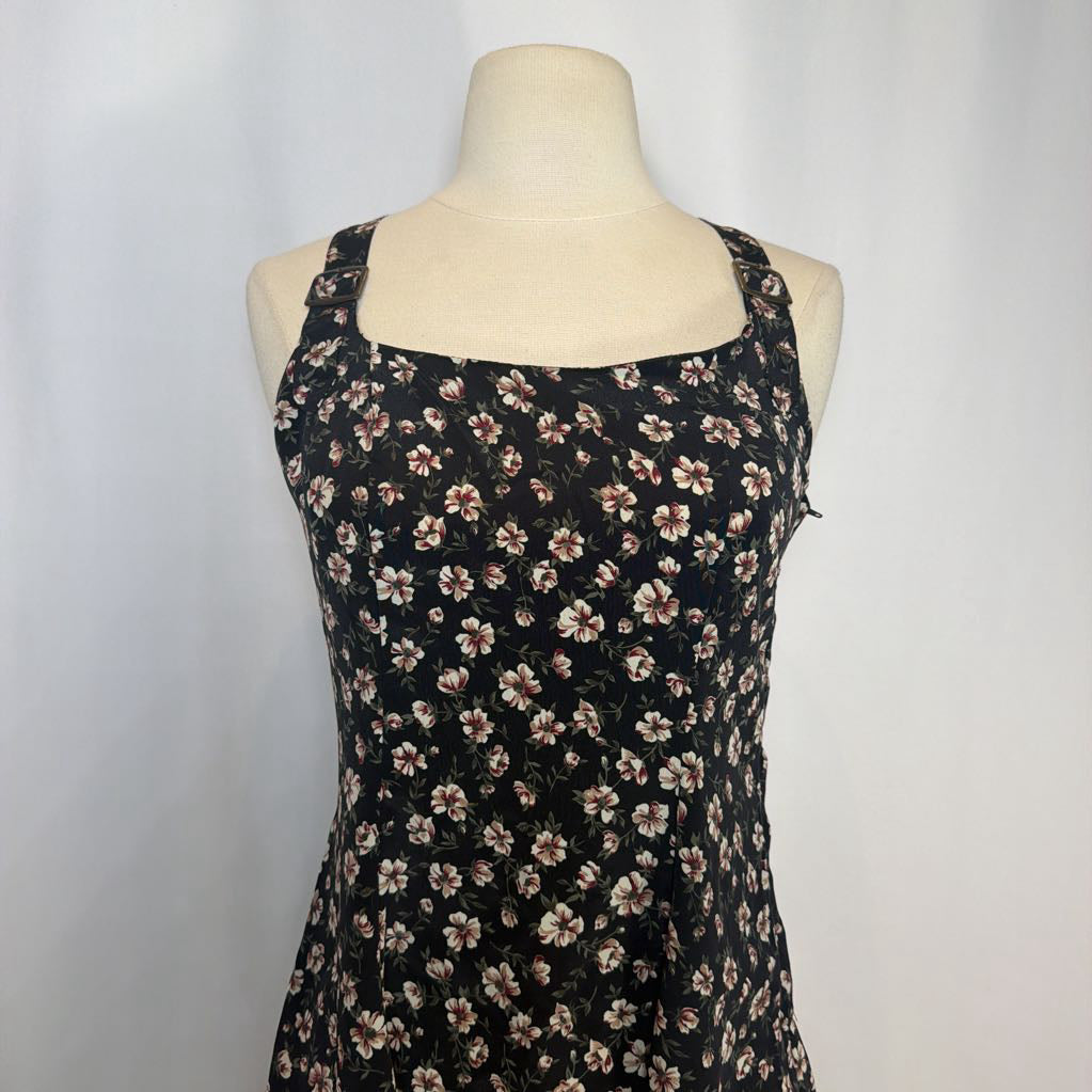 Black floral dress on a mannequin against a white background