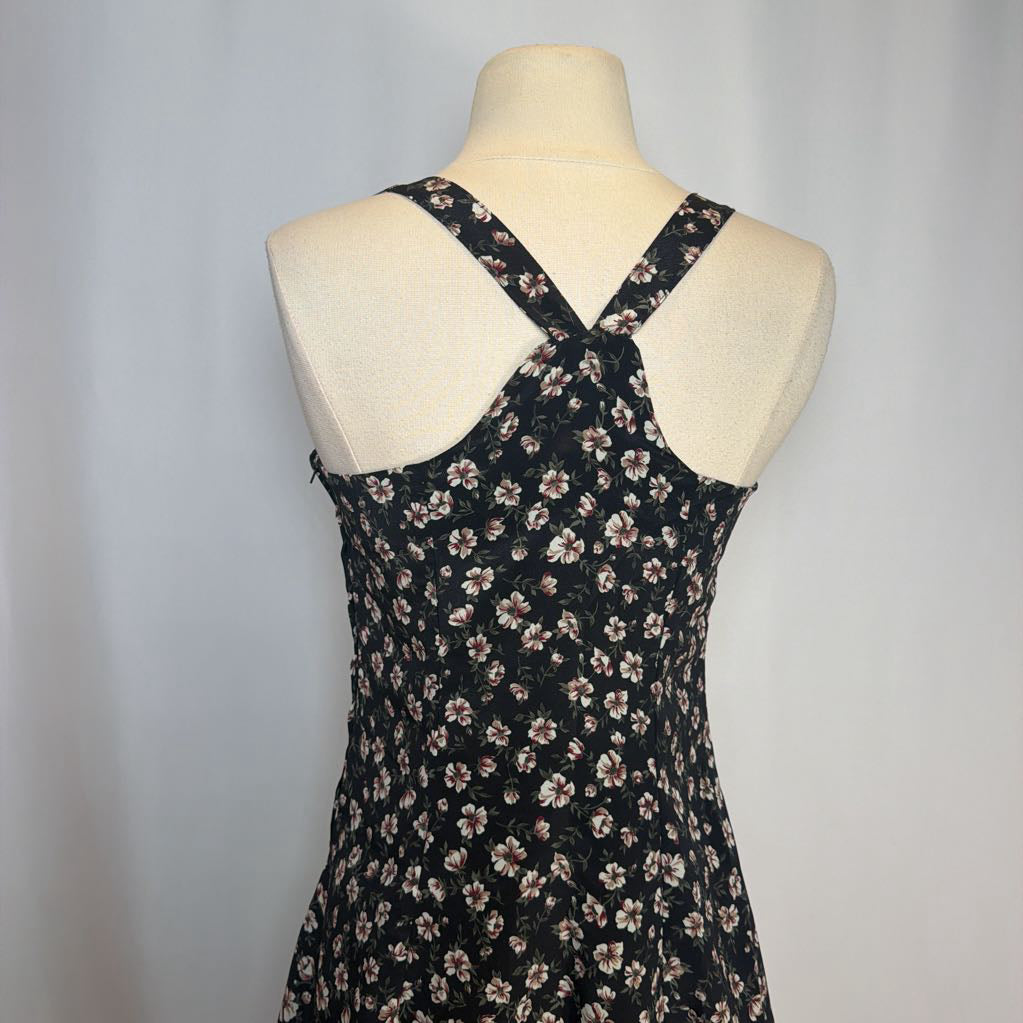 Black floral dress on a mannequin against a gray background