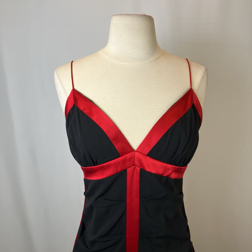 Black and red dress on a mannequin against a plain background