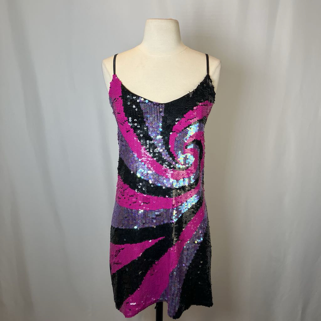 Sequined dress on a mannequin against a plain background