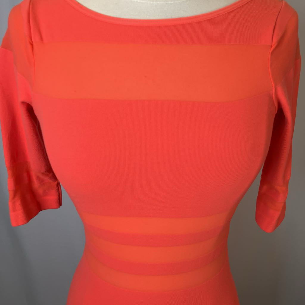 Red dress on a mannequin against a gray background