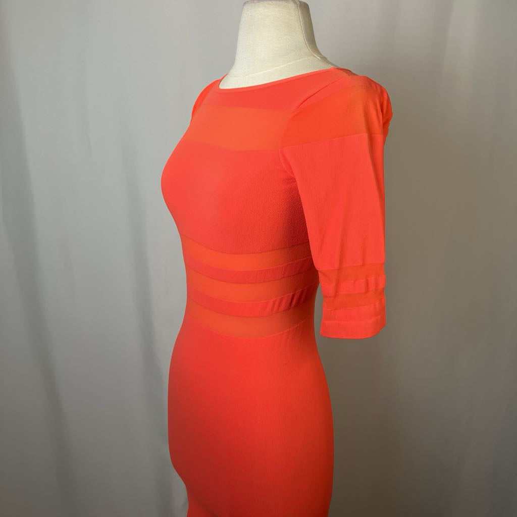 Orange dress on a mannequin against a plain background