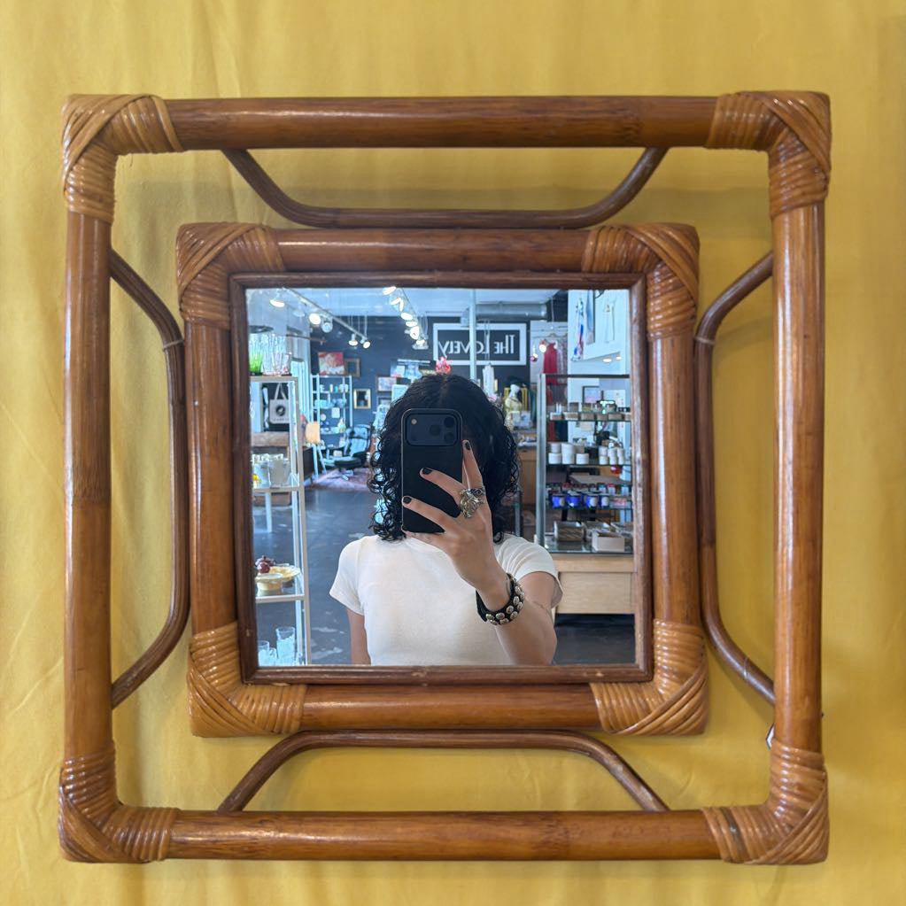 Wooden-framed mirror on a yellow background