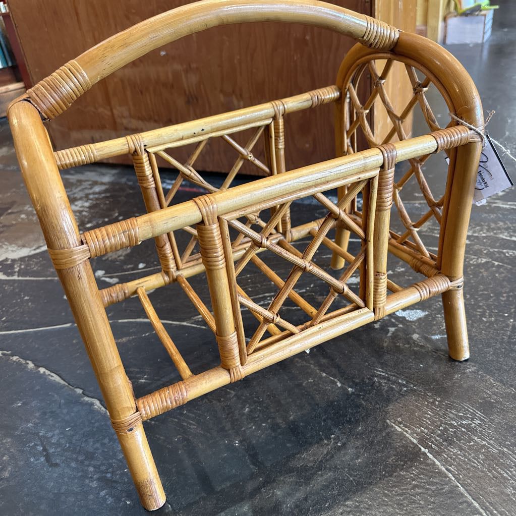 Wicker magazine rack on a dark marble floor