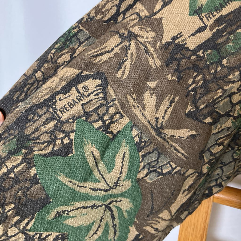 Close-up of a camouflage-patterned fabric with Rebar branding.