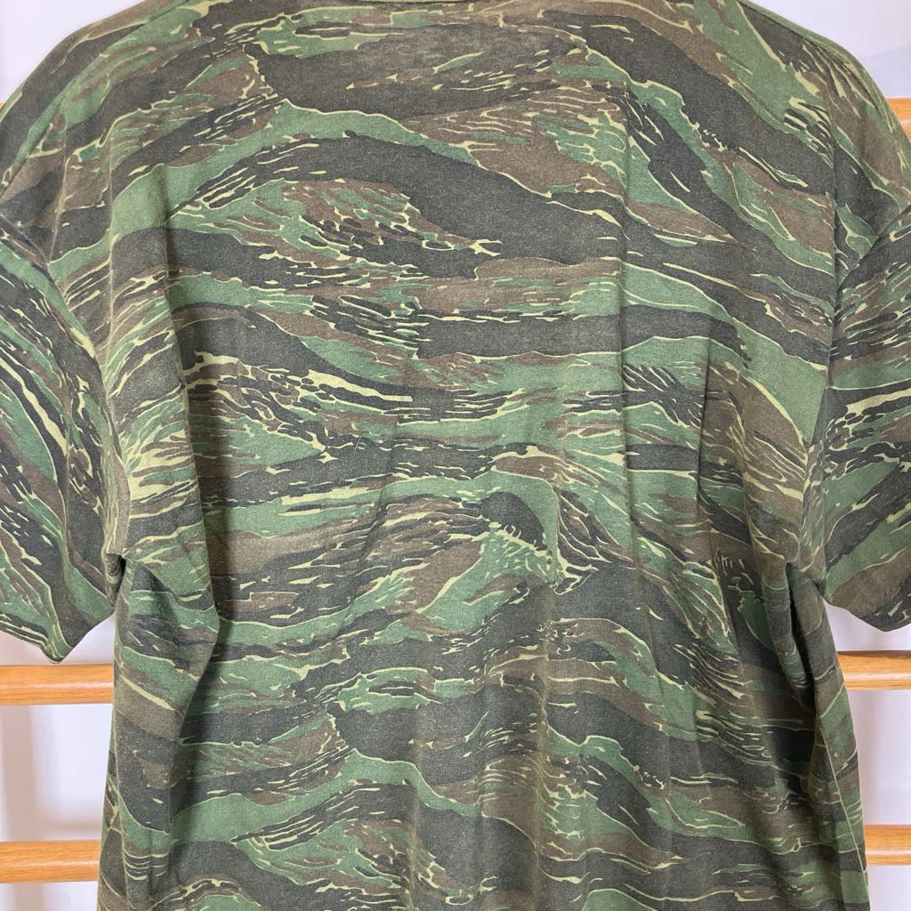 Camouflage-patterned shirt on a wooden rack