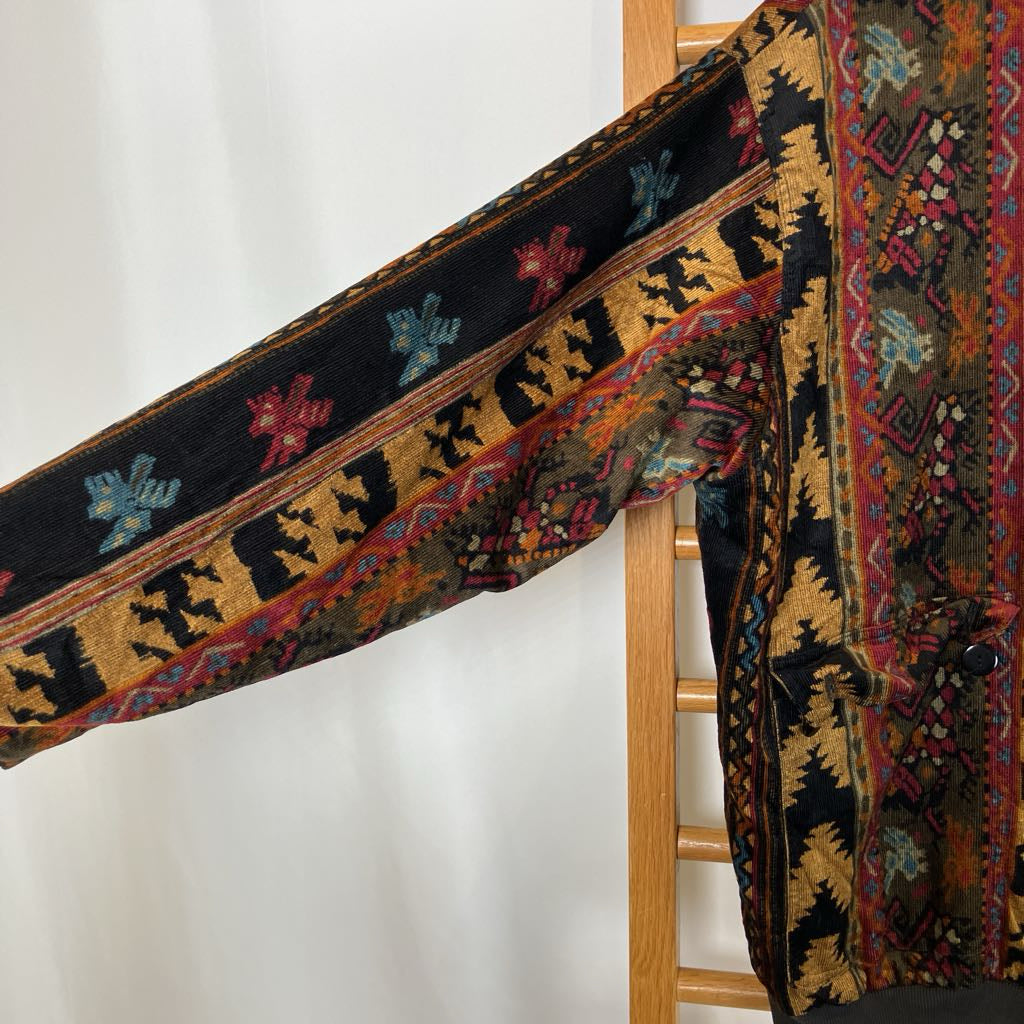 Colorful patterned fabric draped over a wooden chair against a white background