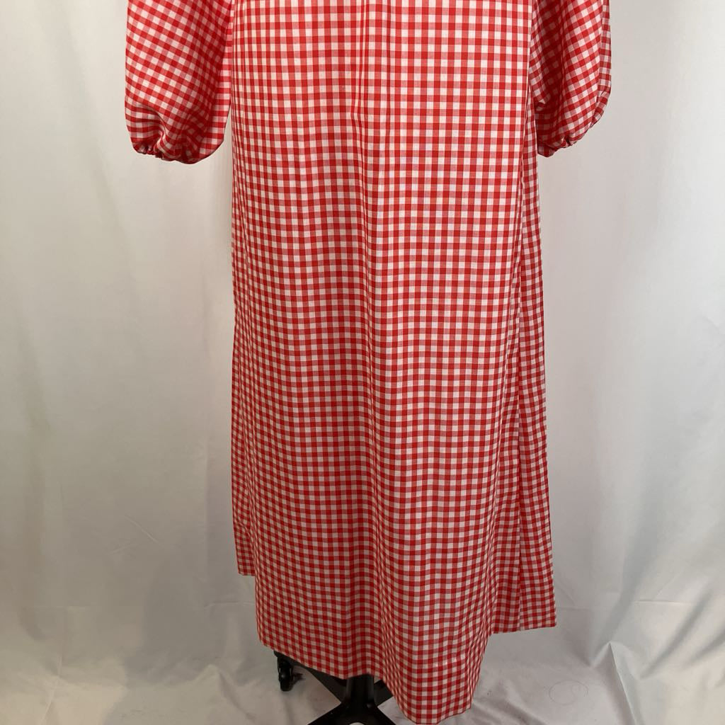 Red and white checkered dress on a mannequin against a white background