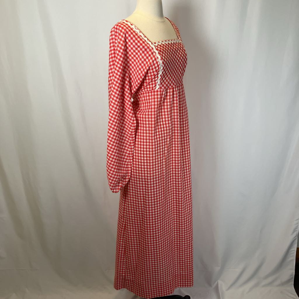 Red and white checkered dress on a mannequin against a plain background