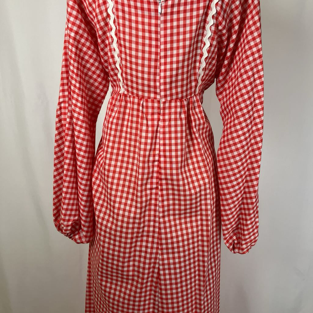 Red and white checkered dress with long sleeves on a plain background