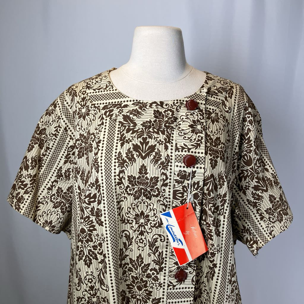 Patterned dress on a mannequin with a visible tag against a plain background