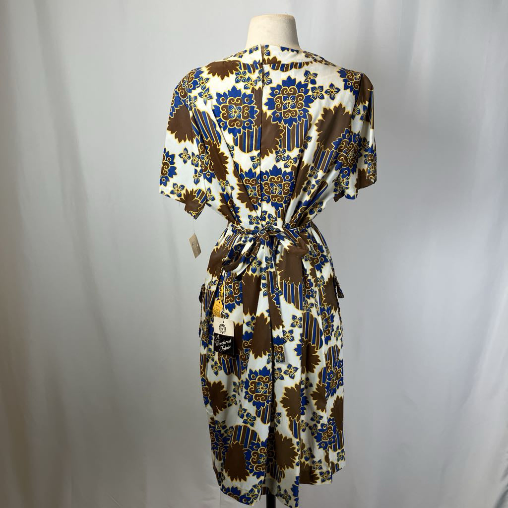 Patterned dress on a mannequin against a plain background