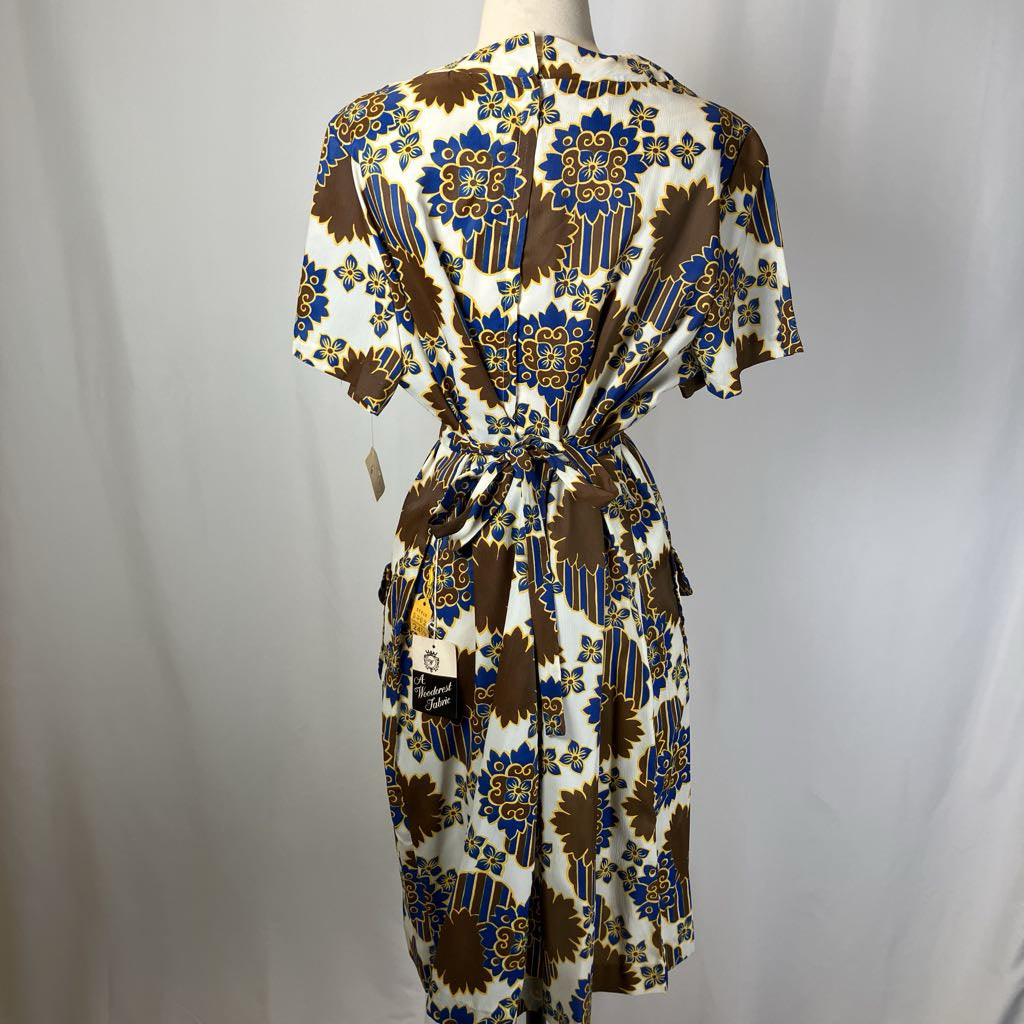 Patterned dress on a mannequin against a plain background