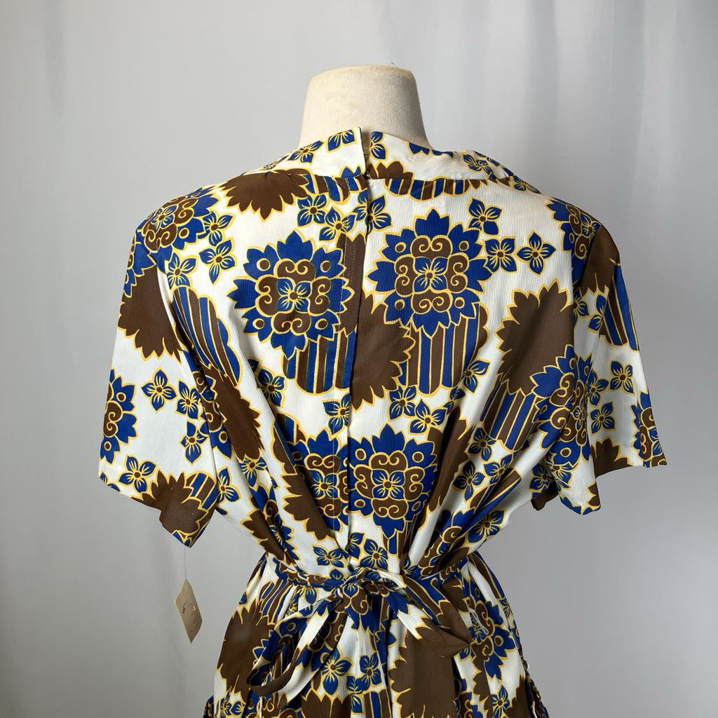 Patterned dress on a mannequin against a plain background