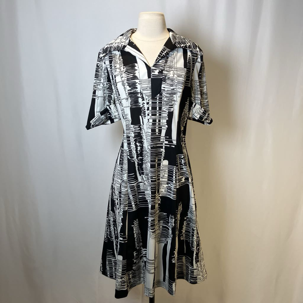 Black and white patterned dress on a mannequin against a plain background