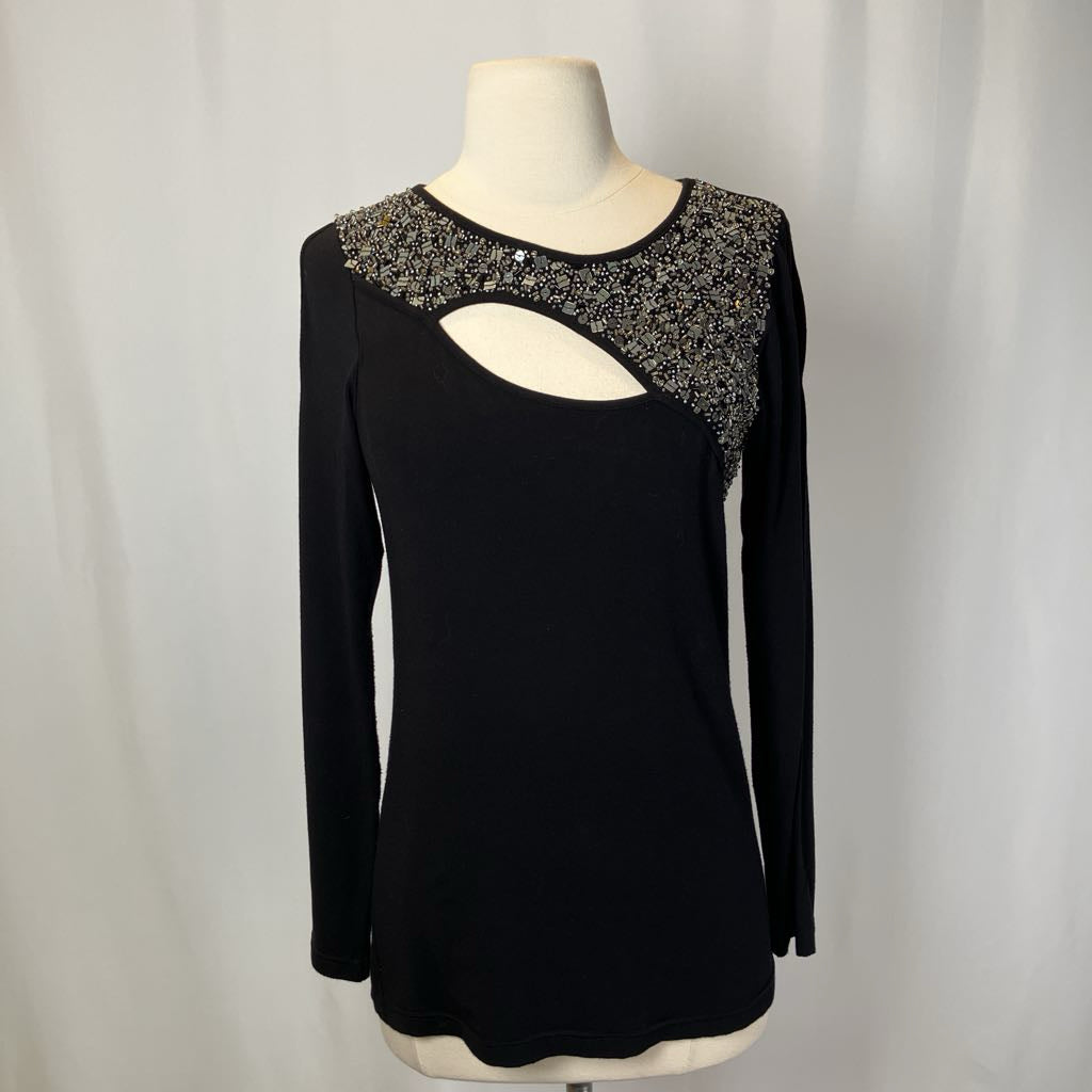 Black top with beading and a cutout on the chest against a white background.