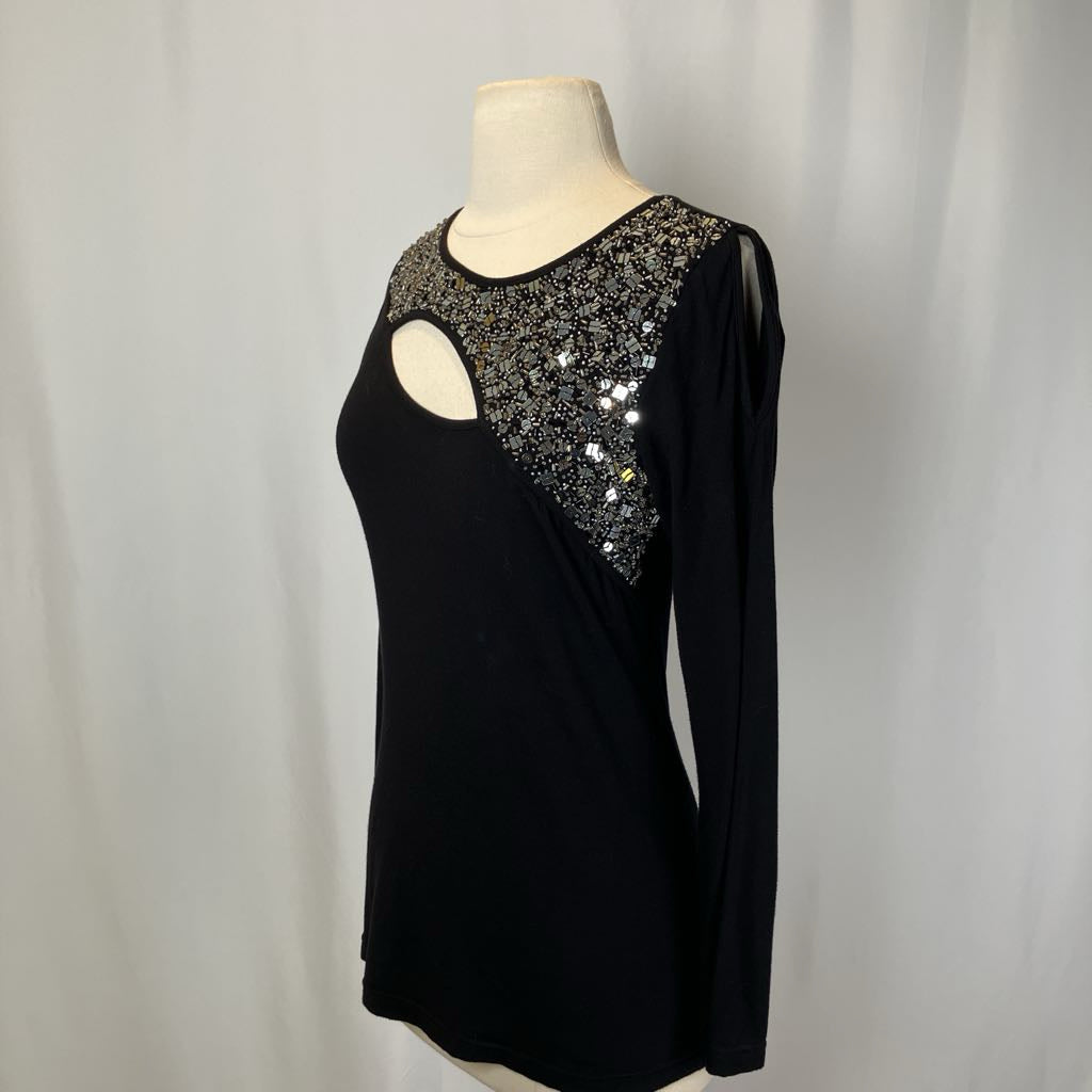 Black top with beading and a cutout on the chest against a white background.