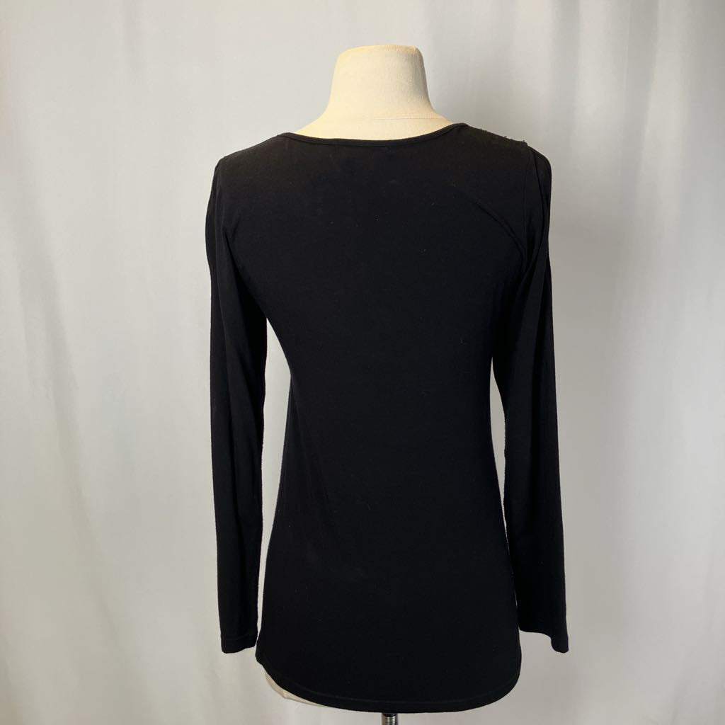 Black long-sleeve top on a mannequin against a white background