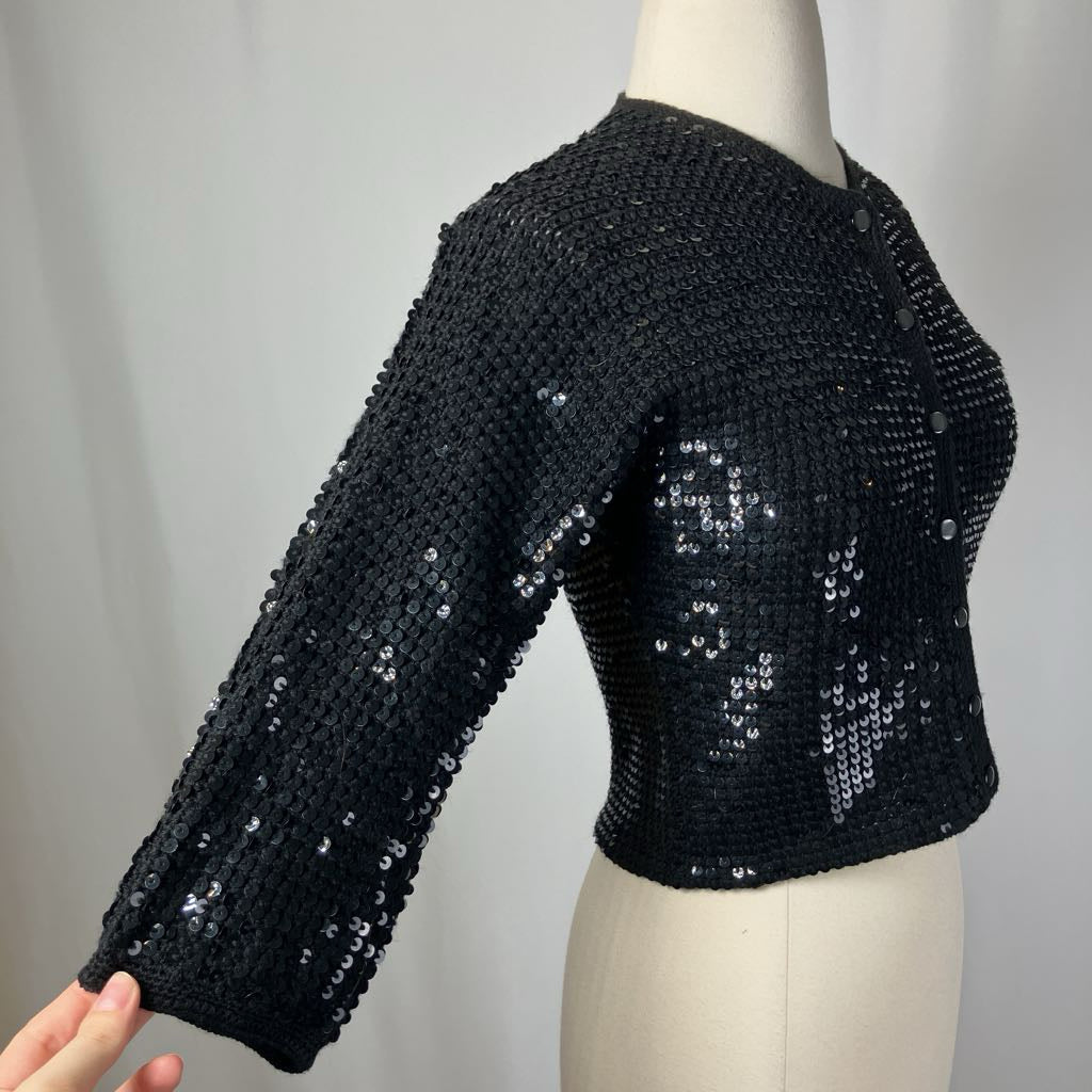 Black sequined jacket on a mannequin against a plain background
