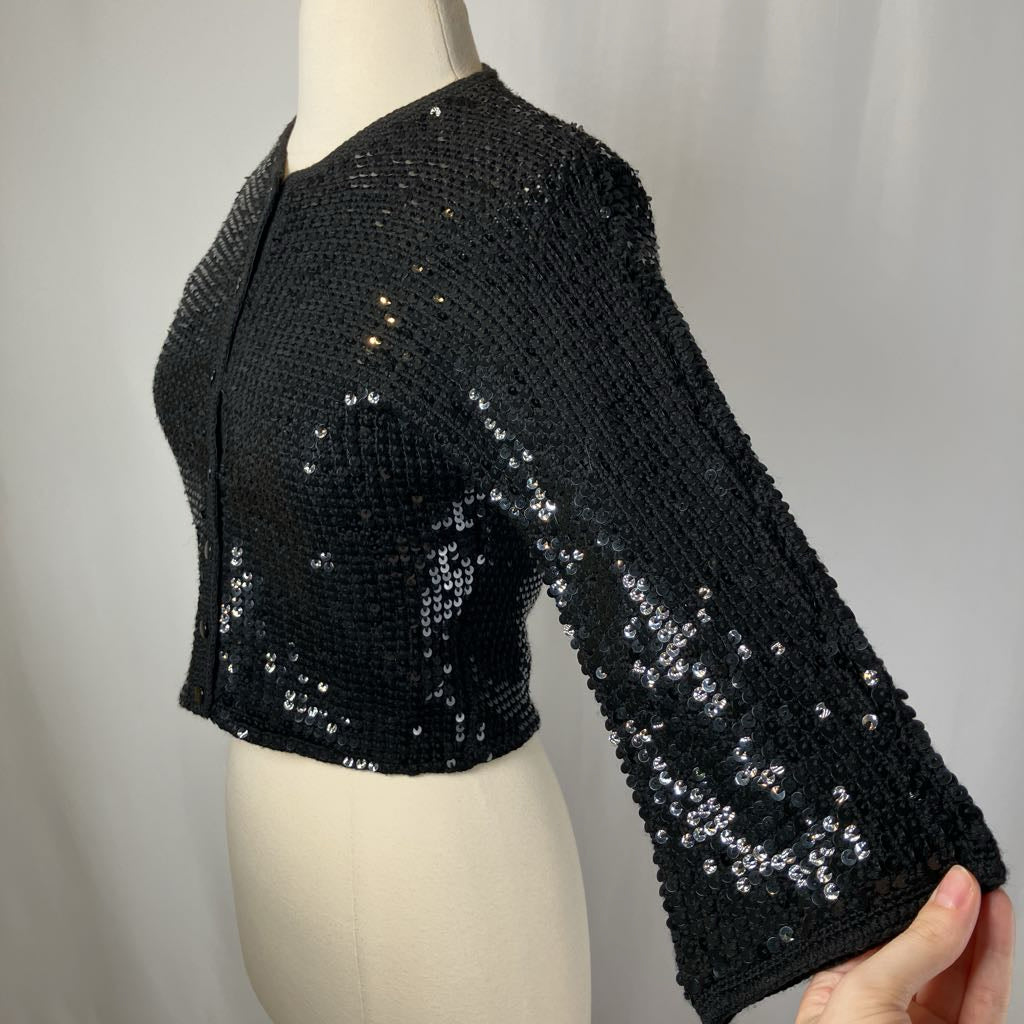 Black sequin jacket on a mannequin against a plain background