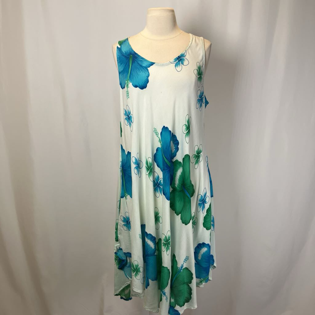 White sleeveless dress with blue and green floral patterns on a mannequin against a plain background.