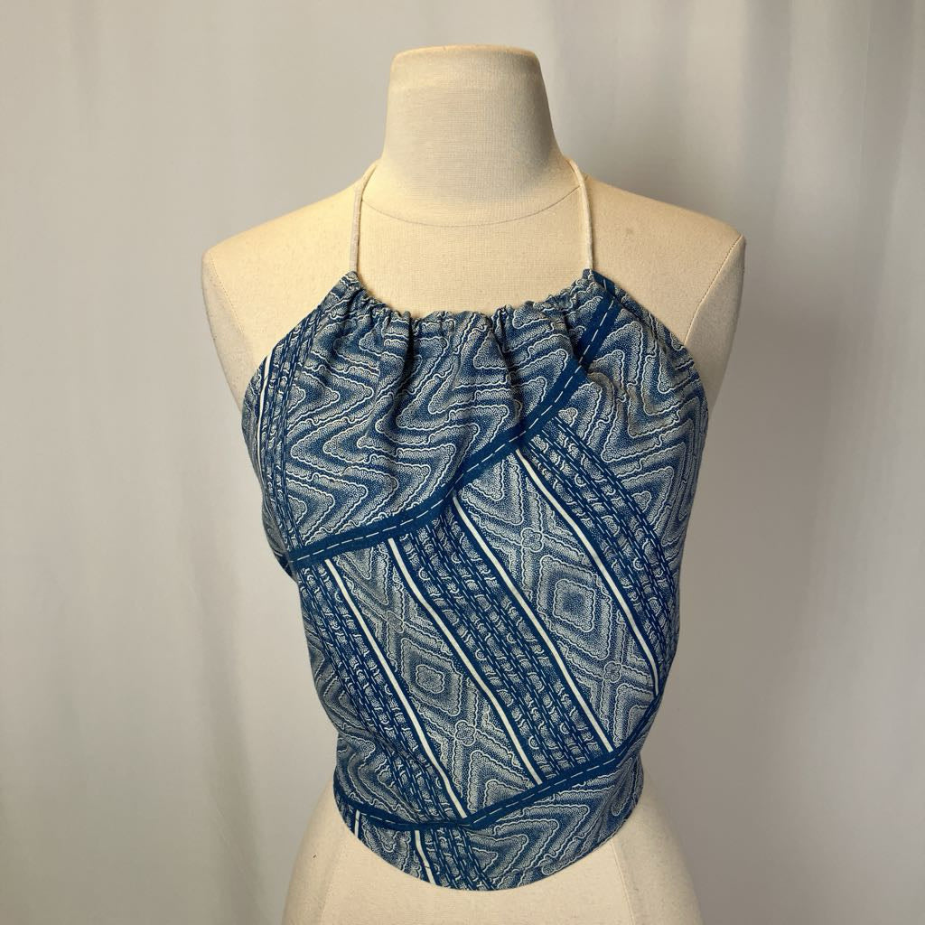 Blue patterned top on a mannequin against a plain background