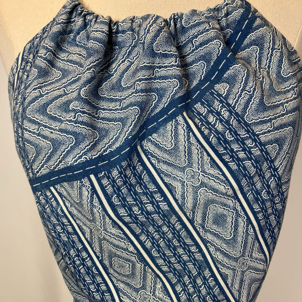 Blue and white patterned fabric on a beige background