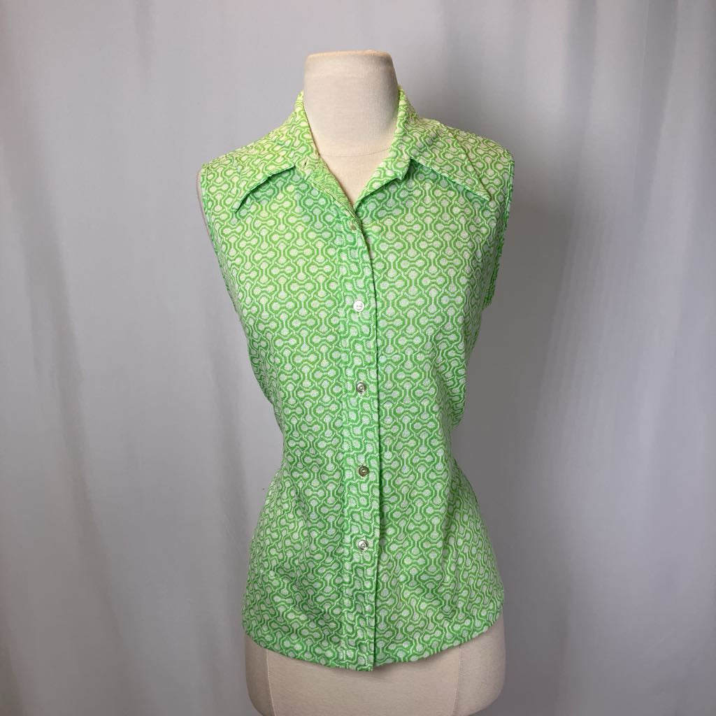 Green patterned sleeveless blouse on a mannequin against a plain background