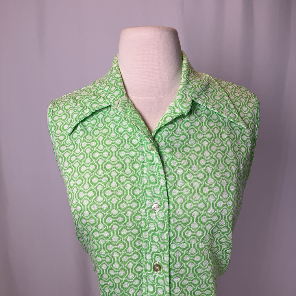 Green patterned shirt on a mannequin against a purple background