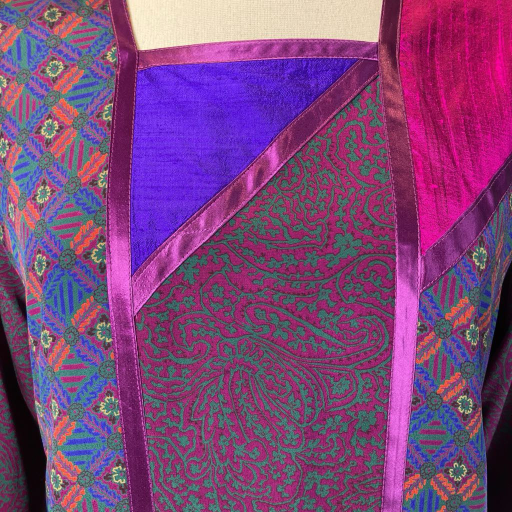 Colorful fabric with intricate patterns and vibrant colors on a beige background