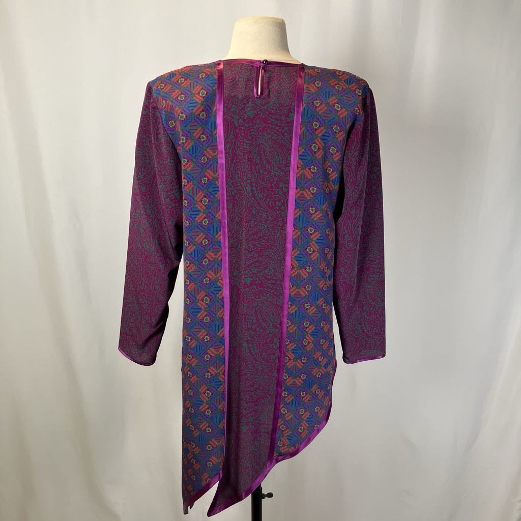 Purple patterned dress on a mannequin against a white background