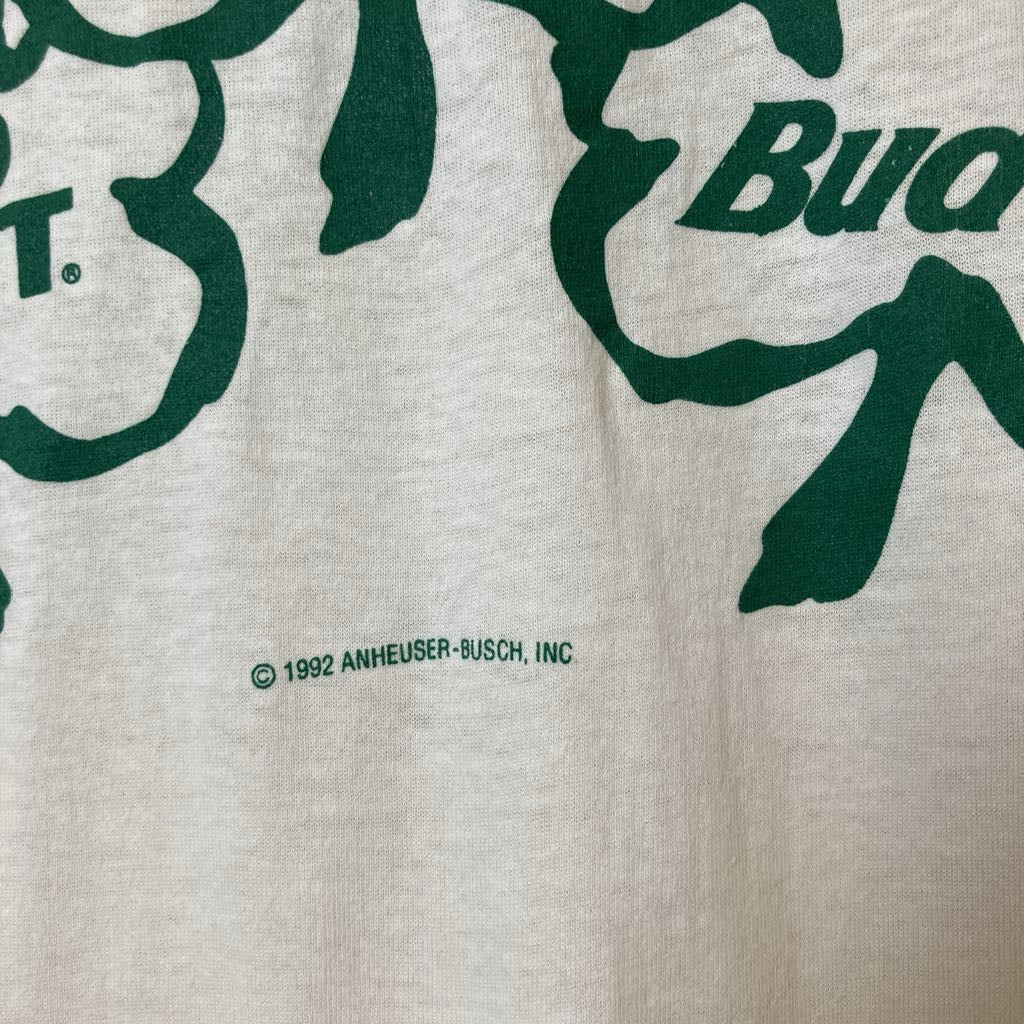 Close-up of a beige fabric with green 'Budweiser' branding and a copyright notice.