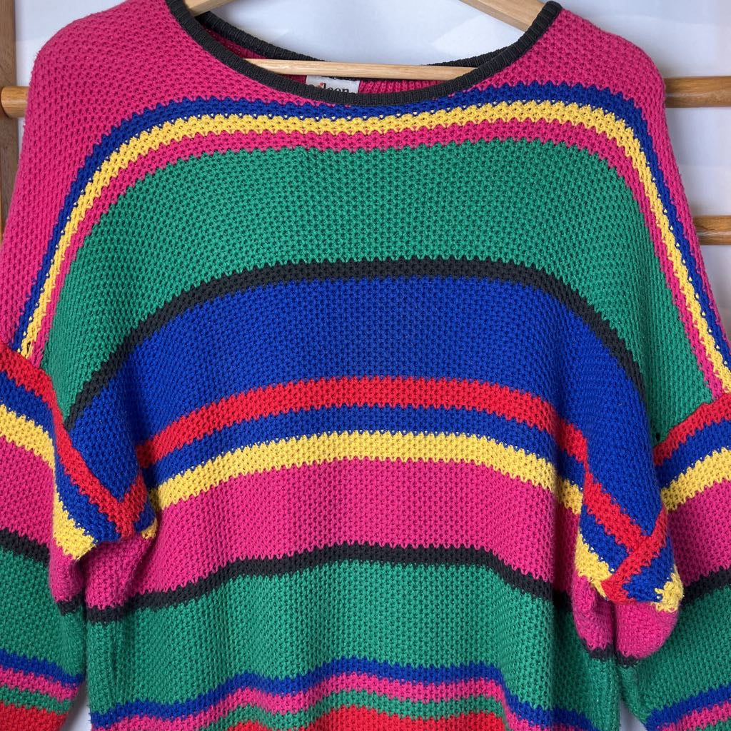 Colorful striped sweater on a wooden rack