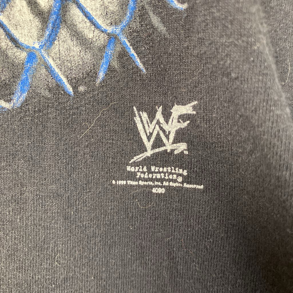 Black t-shirt with WWF logo and text on a dark background
