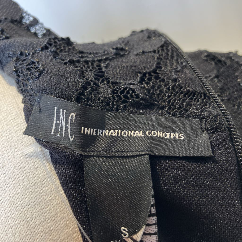 Black lace garment with 'I.N.C. International Concepts' label on a white background