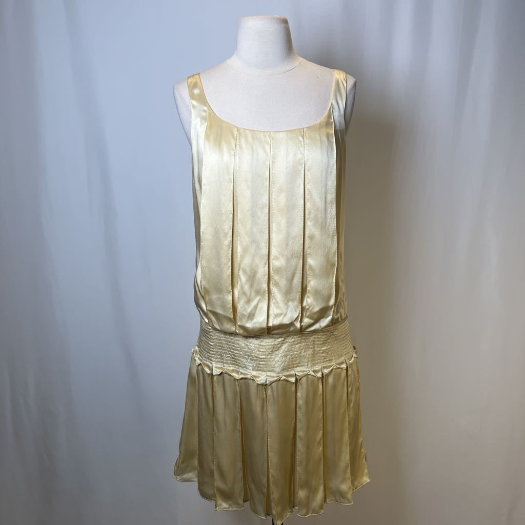 Gold dress on a mannequin against a white background