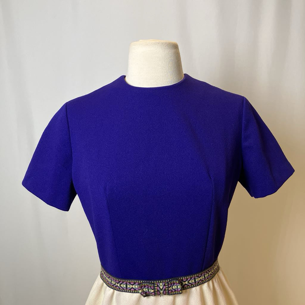 Blue blouse on a mannequin against a plain background