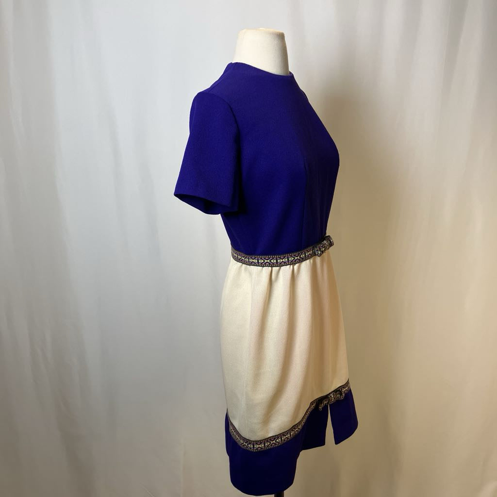 Mannequin wearing a two-tone dress with blue top and beige bottom on a plain background