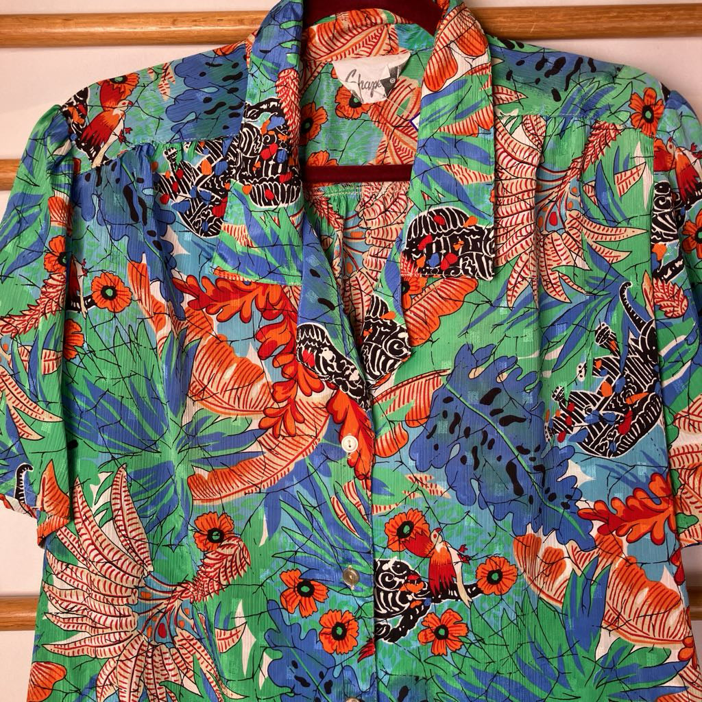 Colorful tropical patterned shirt on a hanger