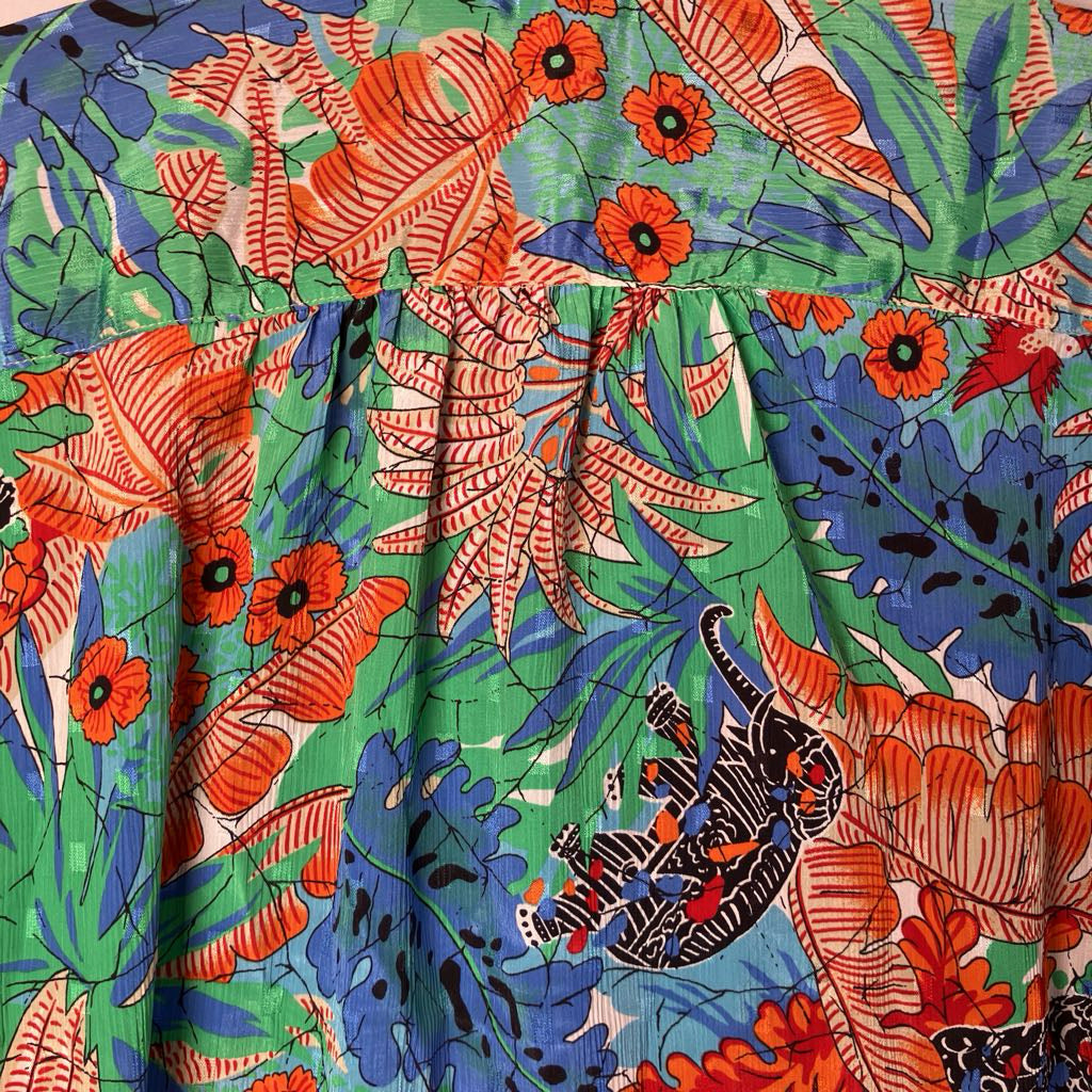 Colorful fabric with tropical leaf and animal pattern