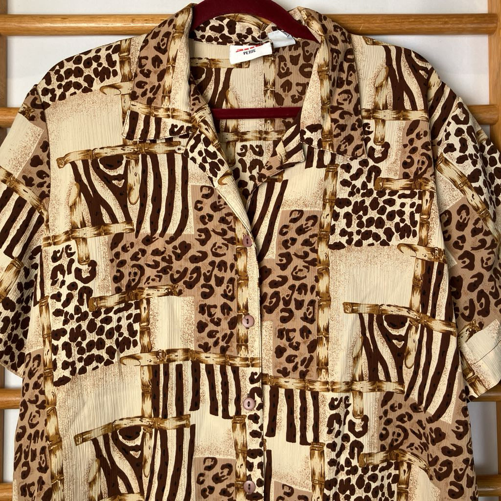 Animal print shirt with leopard and zebra patterns on a wooden rack.
