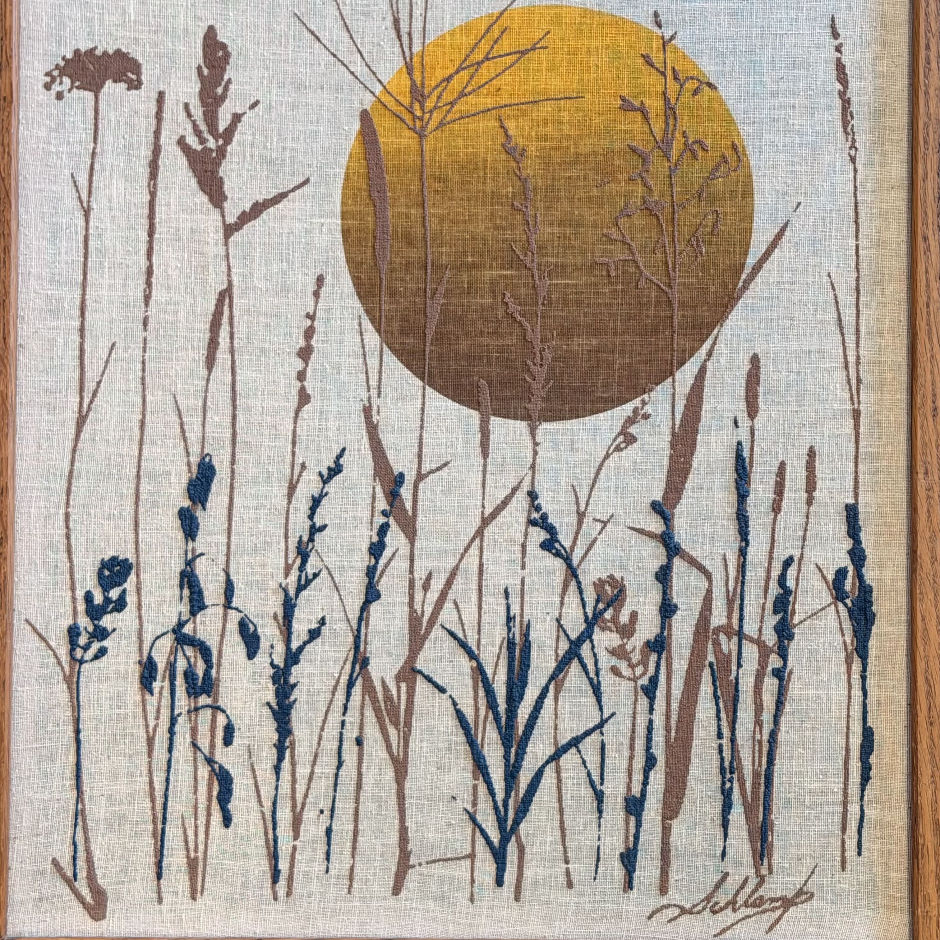 Artistic depiction of plants with a circular design in the center, resembling a sun or moon, on a textured fabric background.