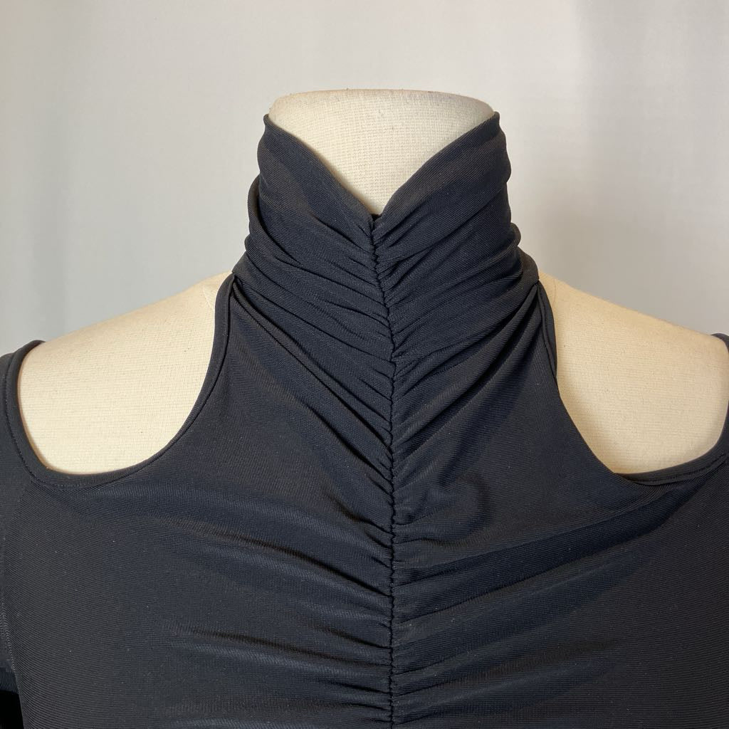 Black sleeveless top on a mannequin against a plain background
