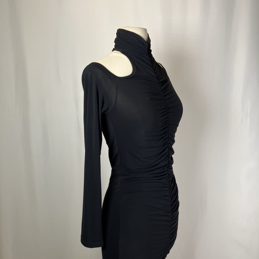 Black dress on a mannequin against a plain background