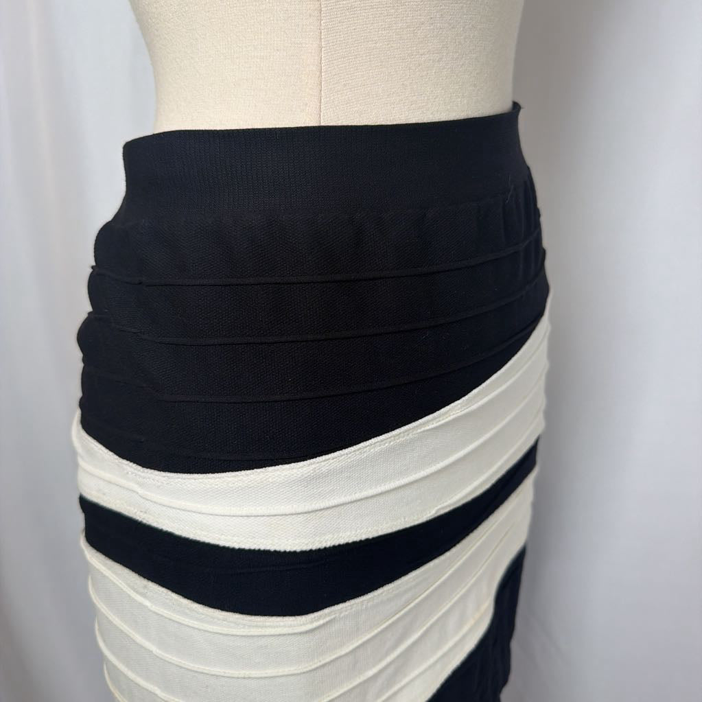Black and white geometric patterned skirt on a mannequin in front of a white wall.