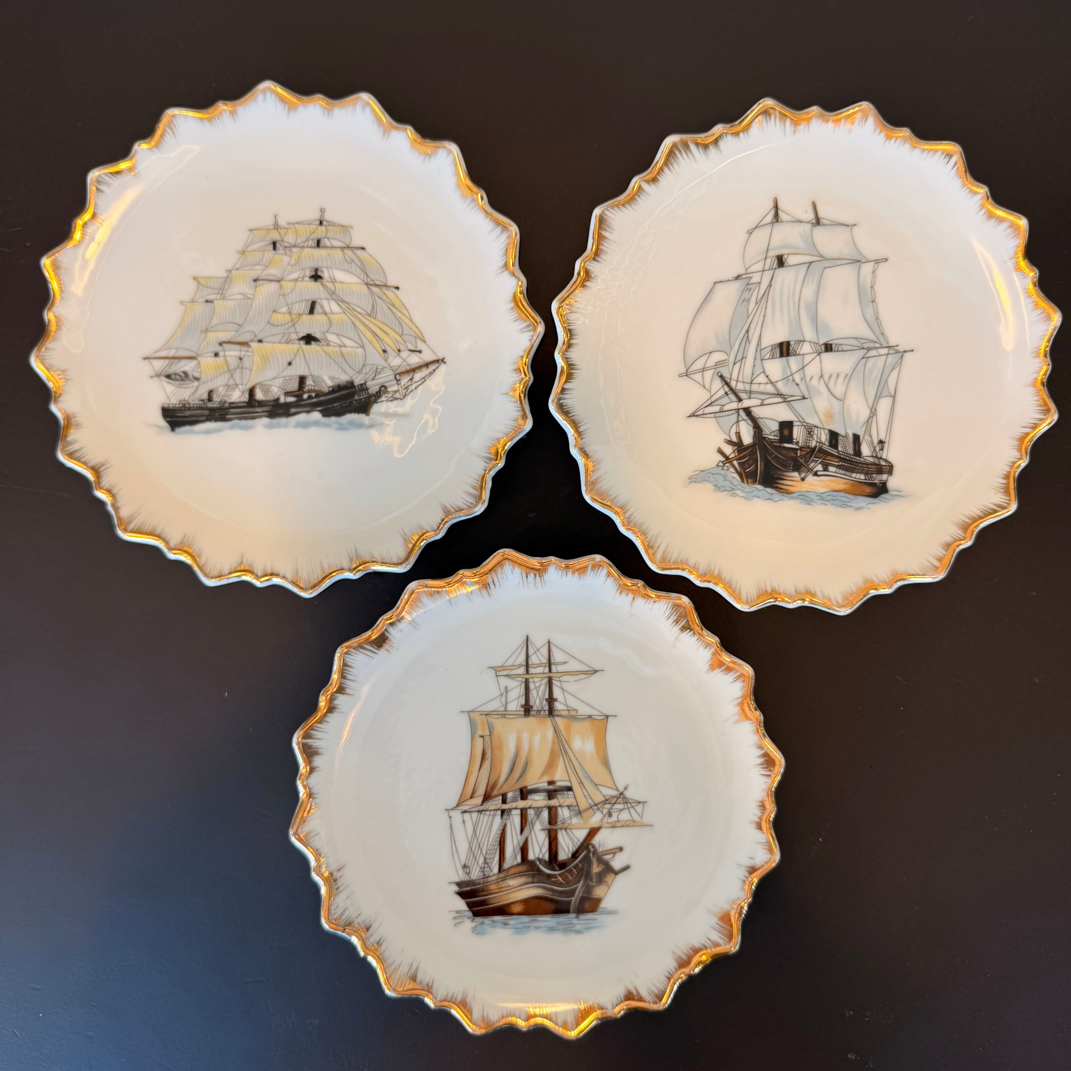 Three decorative plates with ship illustrations on a dark background