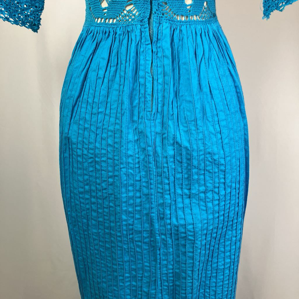 Blue dress with textured pattern on a plain background